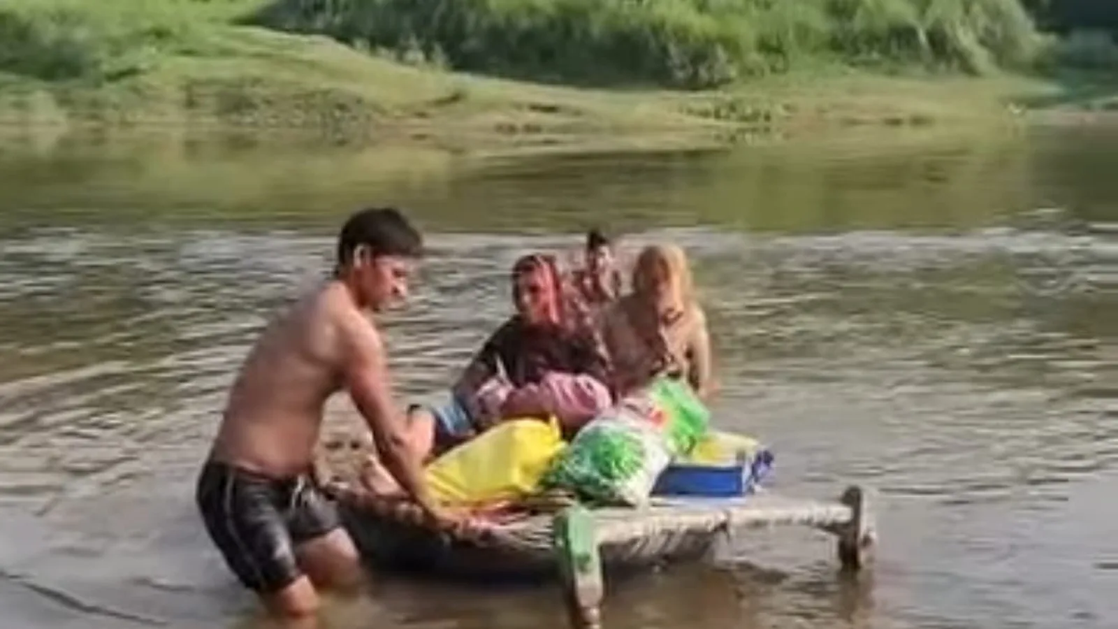 Woman and newborn carried across river on cot in Agra