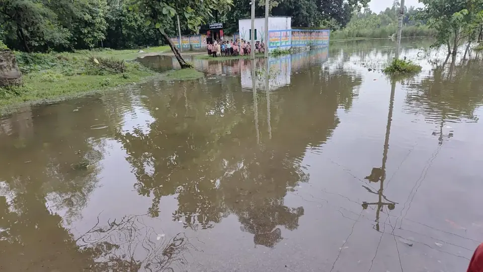 Uttar Pradesh school surrounded by floodwater forces students through knee-deep water