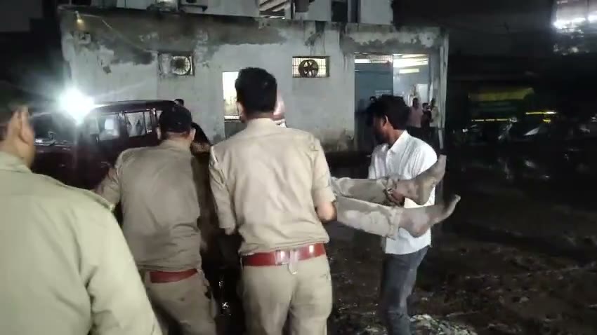 police and fire brigade carry a person out of the debris