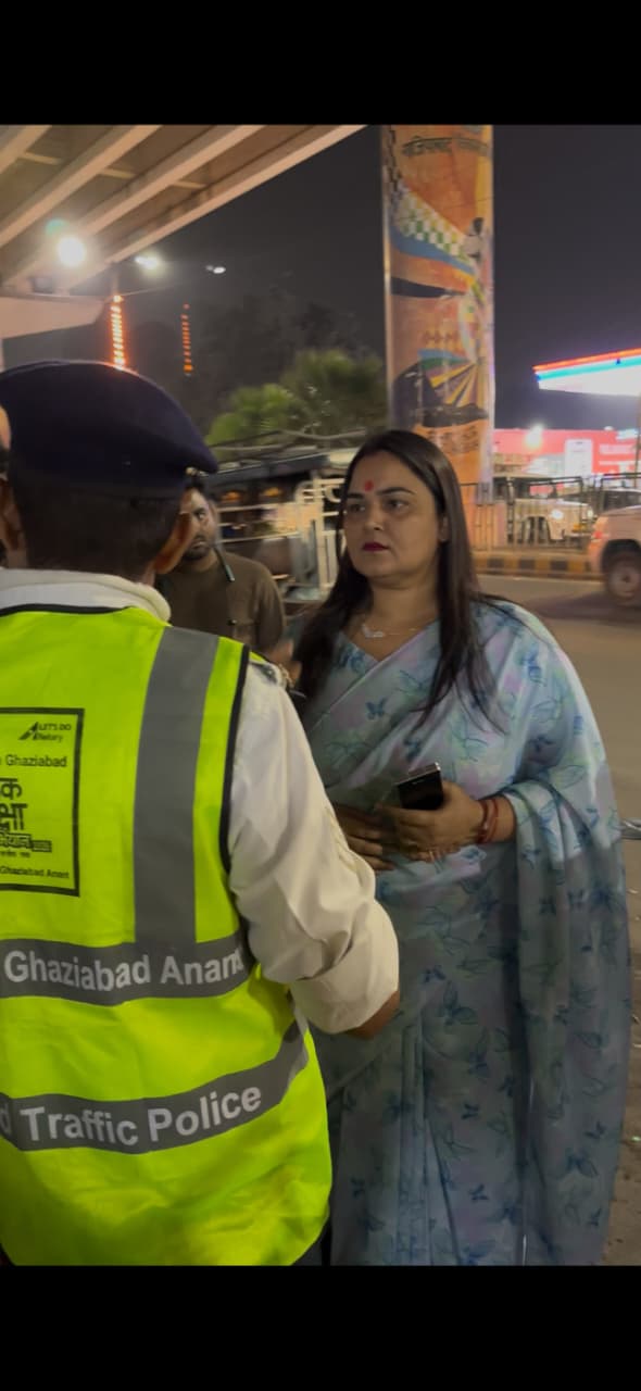 Councillor Sheetal Deol Chaudhary speaks to traffic police outside Shaheed Sthal metro station in Ghaziabad