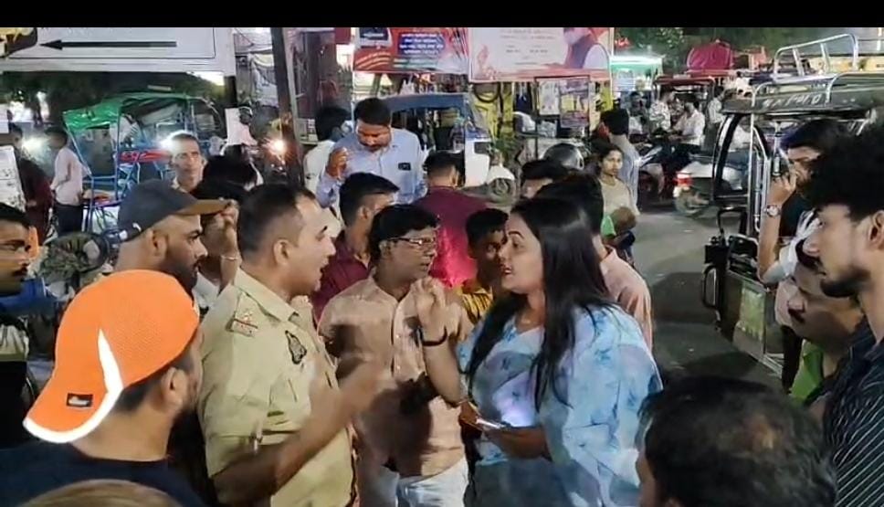 Crowd watches heated exchange between councillor and police near Shaheed Sthal metro station