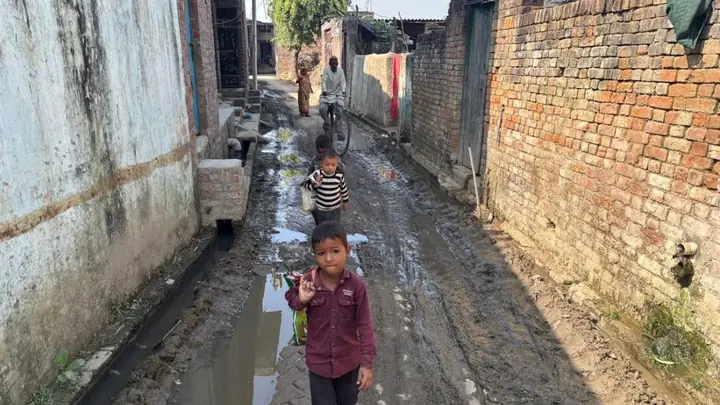 Chandausi Children Wade Through Muddy, Drain-Filled Lane To Reach School