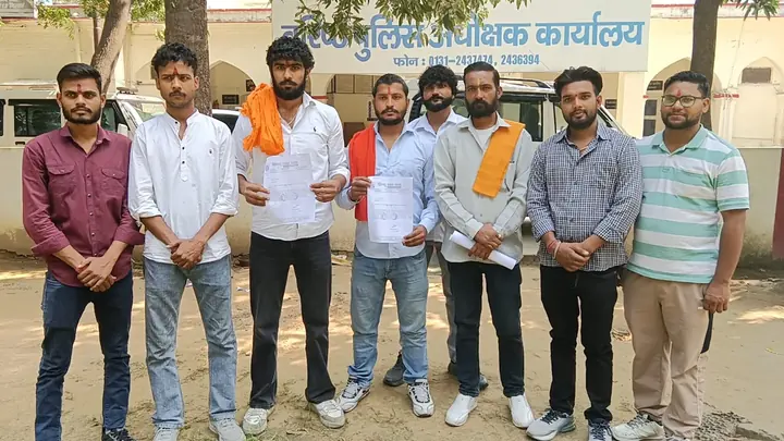 People holding documents outside an office in the photograph supplied with the Muzaffarnagar report.