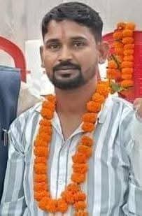 Ajay Kumar Rajvar wearing a marigold garland in the supplied portrait