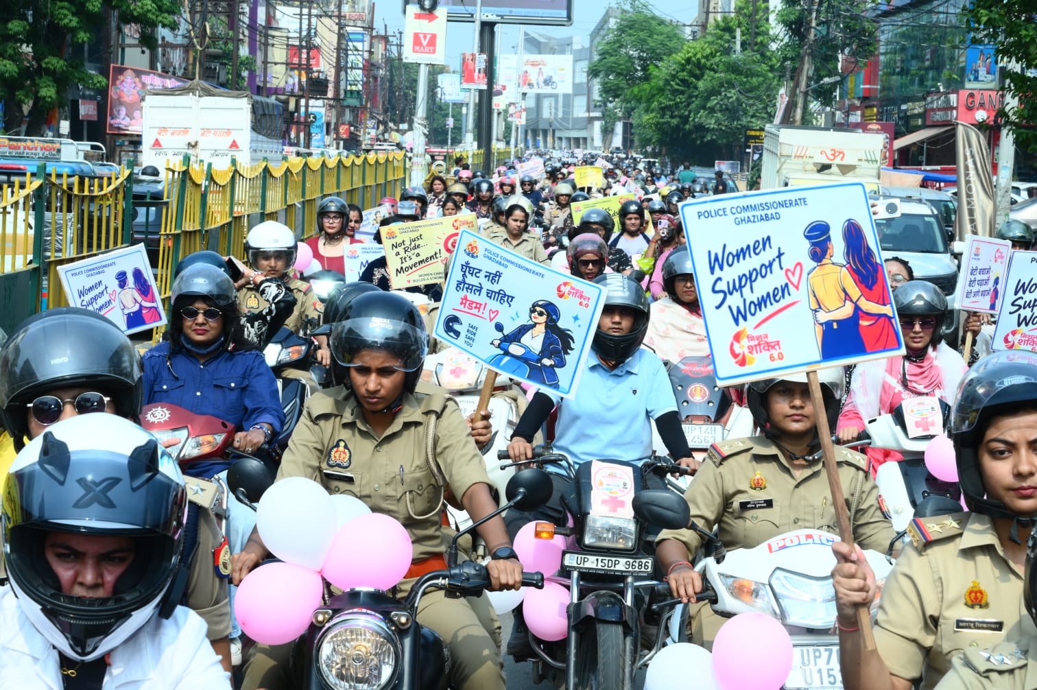 Women police officers and civilian riders take part in the two-wheeler procession