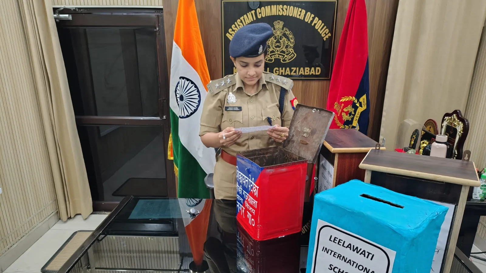 ACP Upasana Pandey reads a slip from a complaint box in Ghaziabad