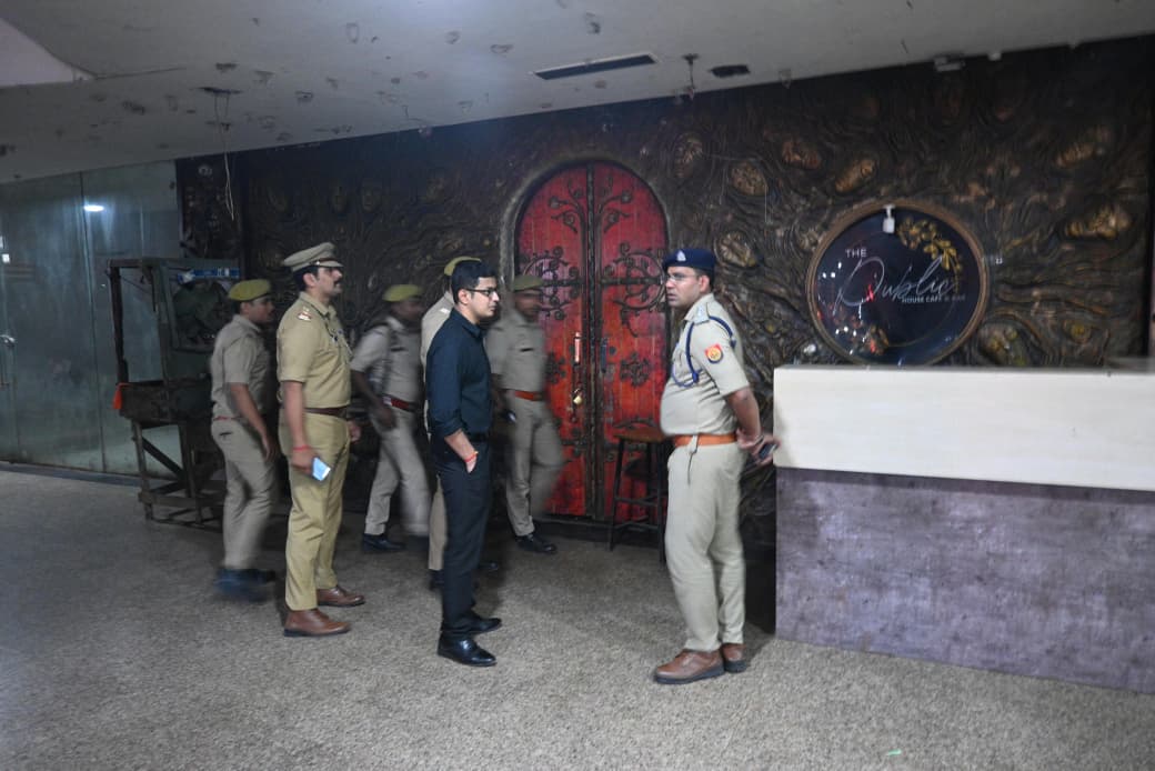 Police personnel standing near a decorative venue entrance