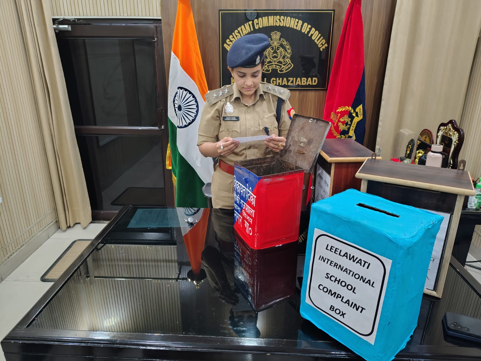 ACP Upasana Pandey reads a slip from a complaint box in Ghaziabad
