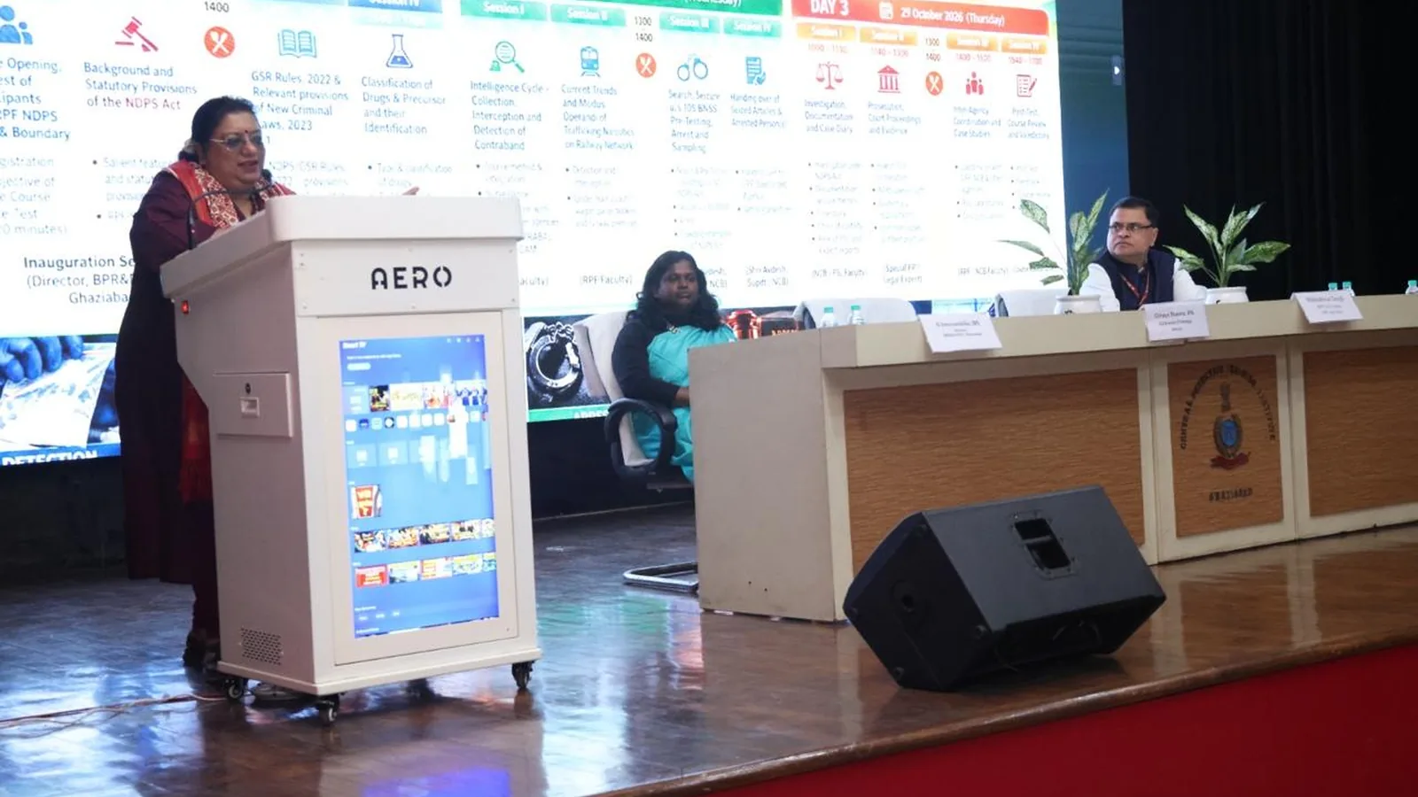 A speaker addresses an NDPS training session at CDTI Ghaziabad as two panel members sit on stage