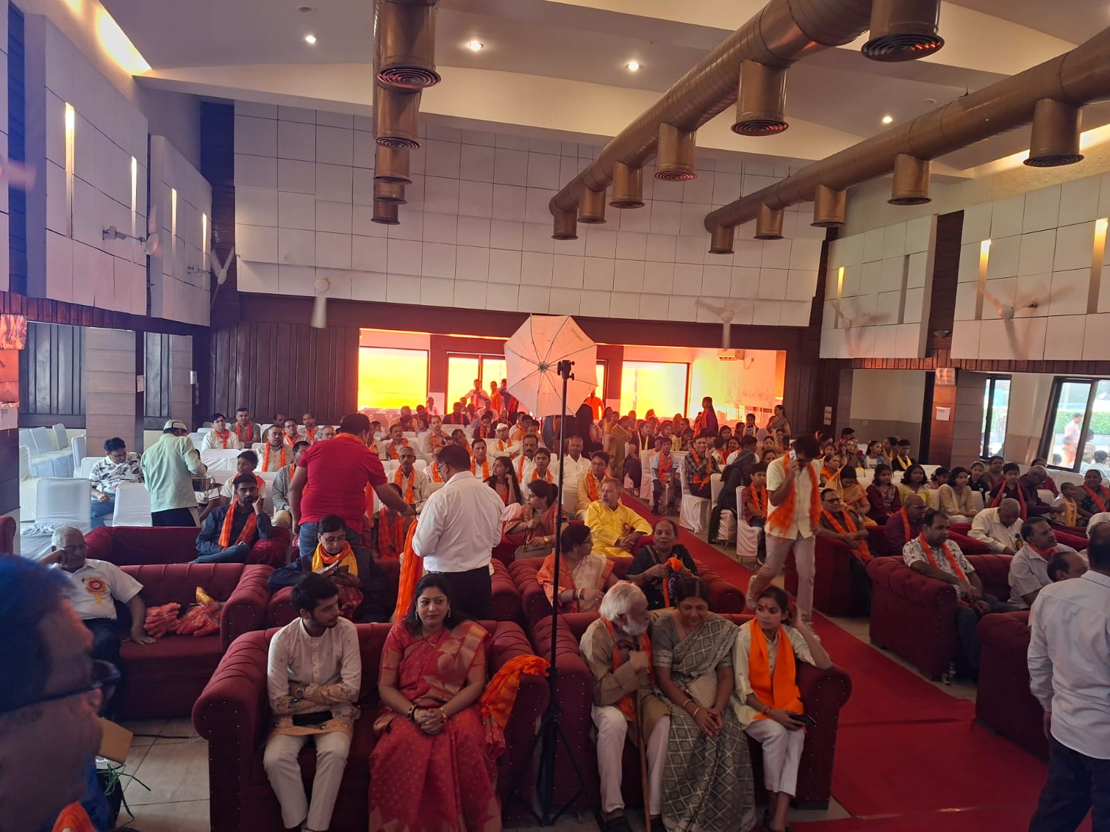 Attendees seated and standing in the hall during the ceremony