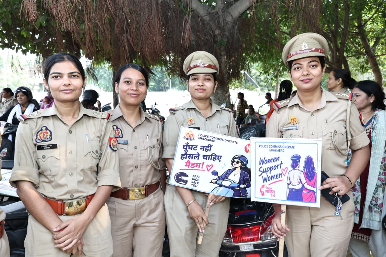 Four women police officers hold awareness placards at the Ghaziabad rally