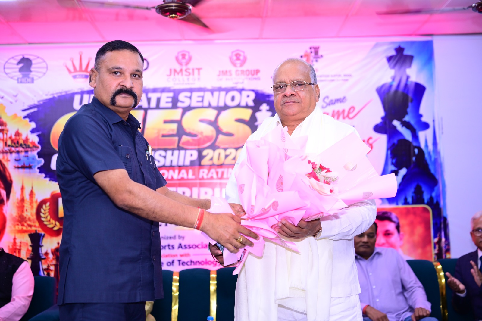 An organiser presents a bouquet to a guest at the championship ceremony.